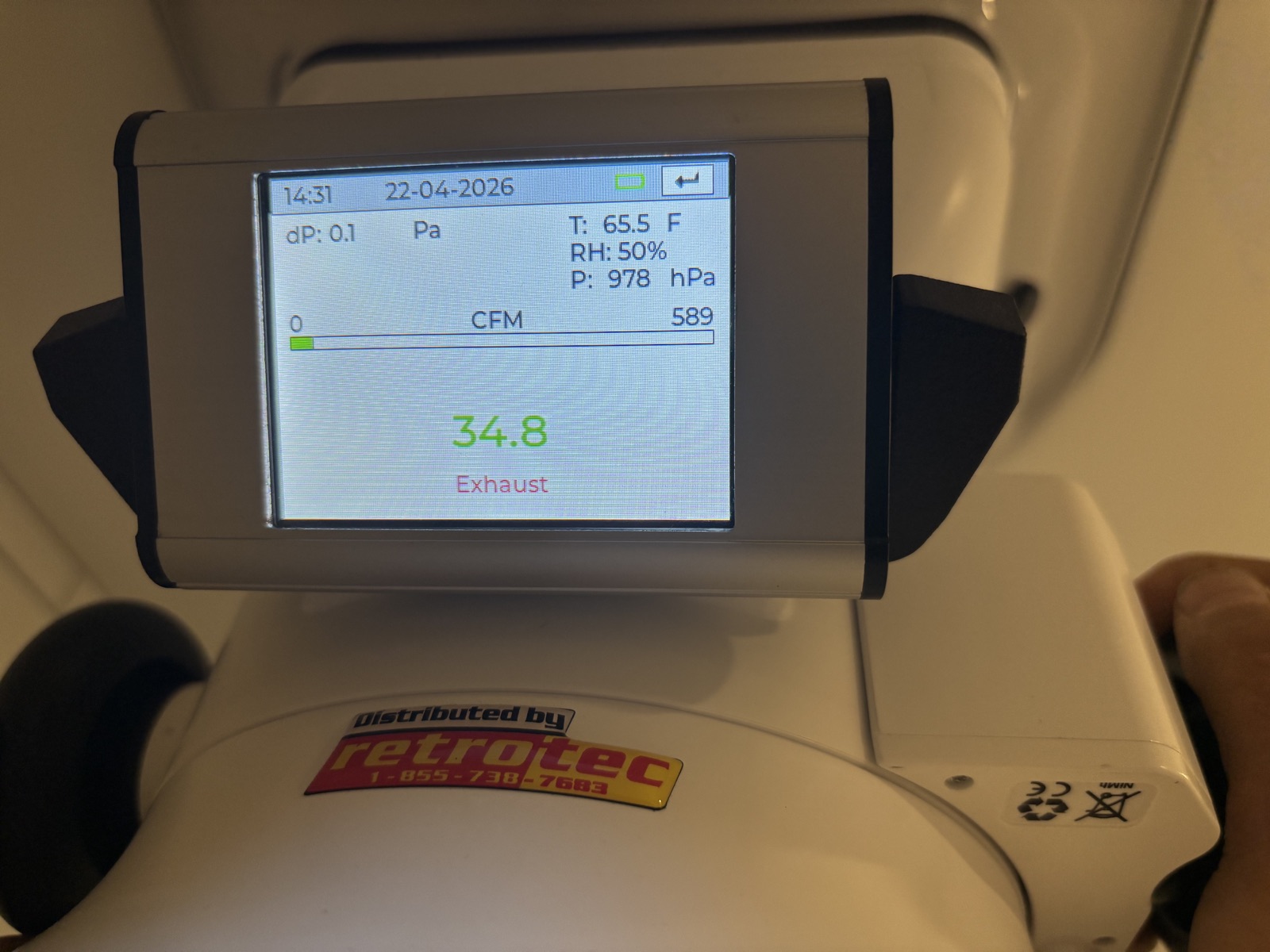 Airflow reading on a diagnostic flow hood during HVAC performance testing.