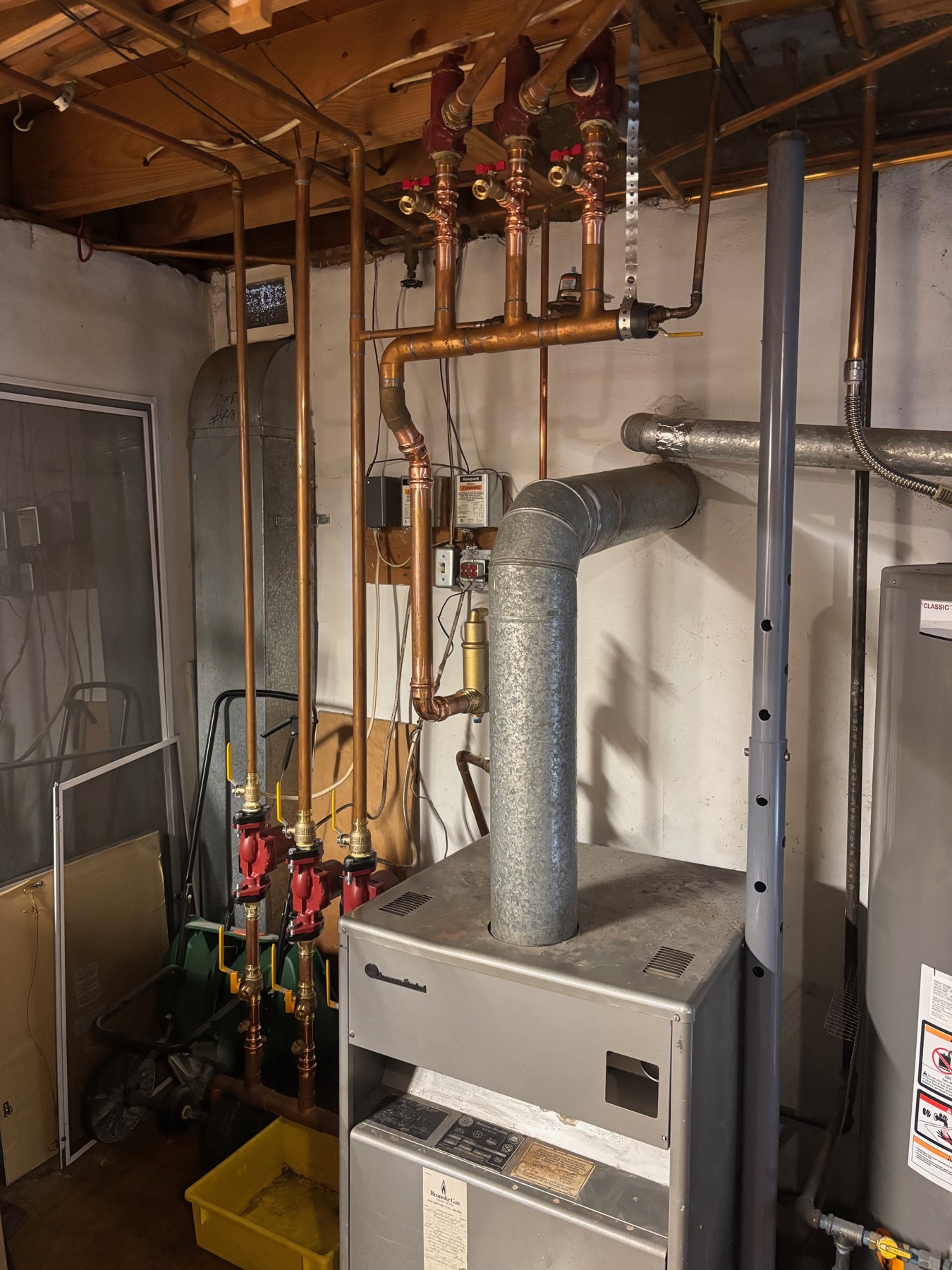 Boiler piping and circulator pumps in a Roanoke-area hydronic heating system.