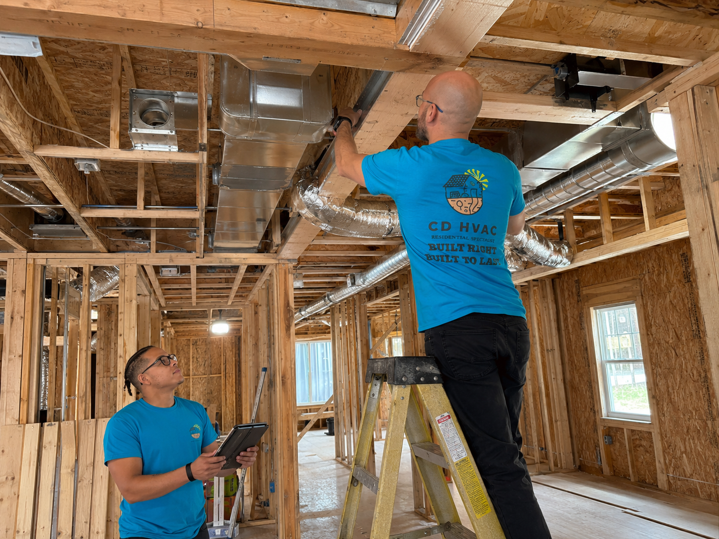 New construction HVAC ductwork rough-in coordination in a framed home.